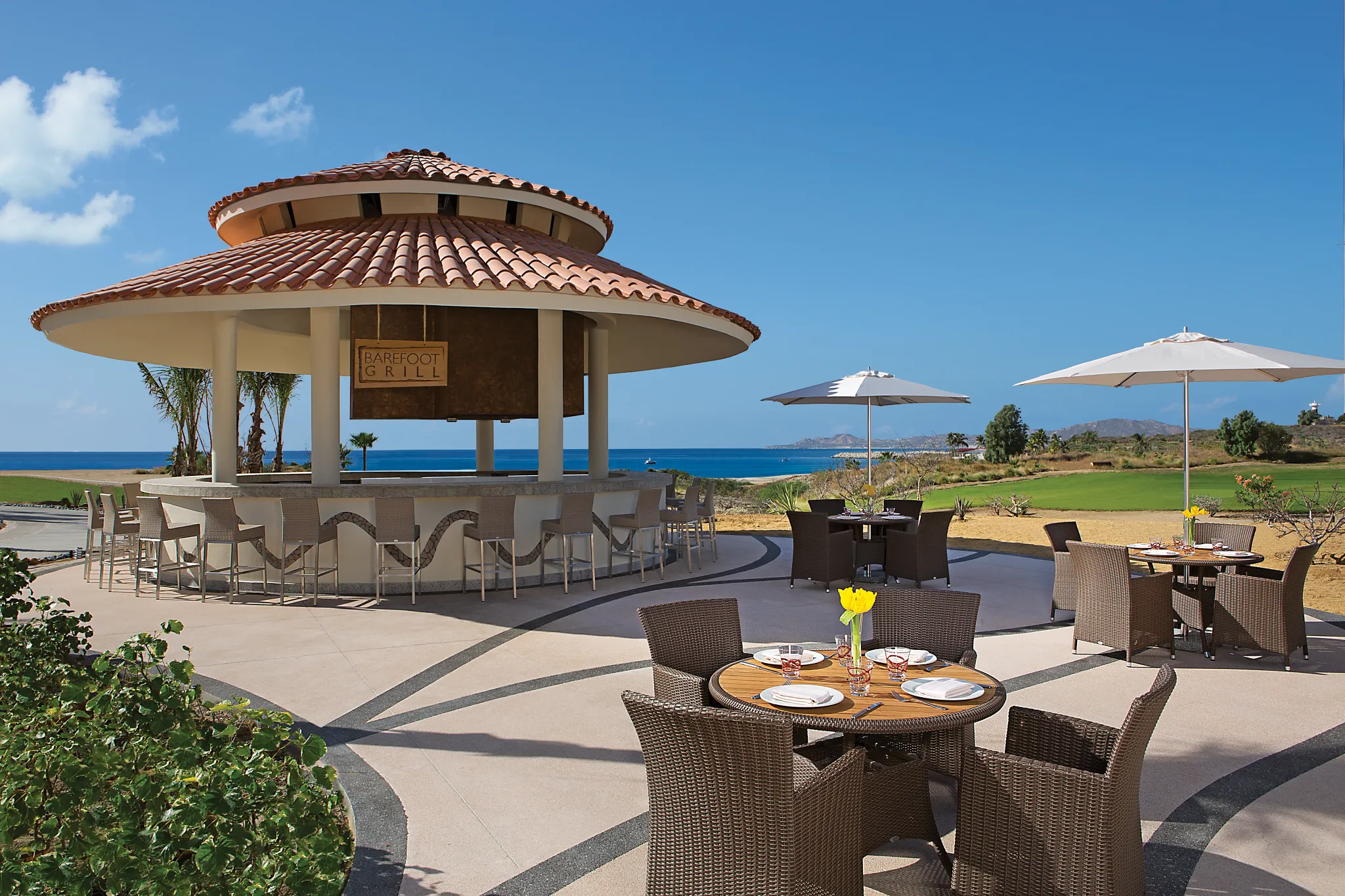 Barefoot Grill at Secrets Puerto Los Cabos featuring open-air dining, grilled specialties, and a relaxed poolside setting.