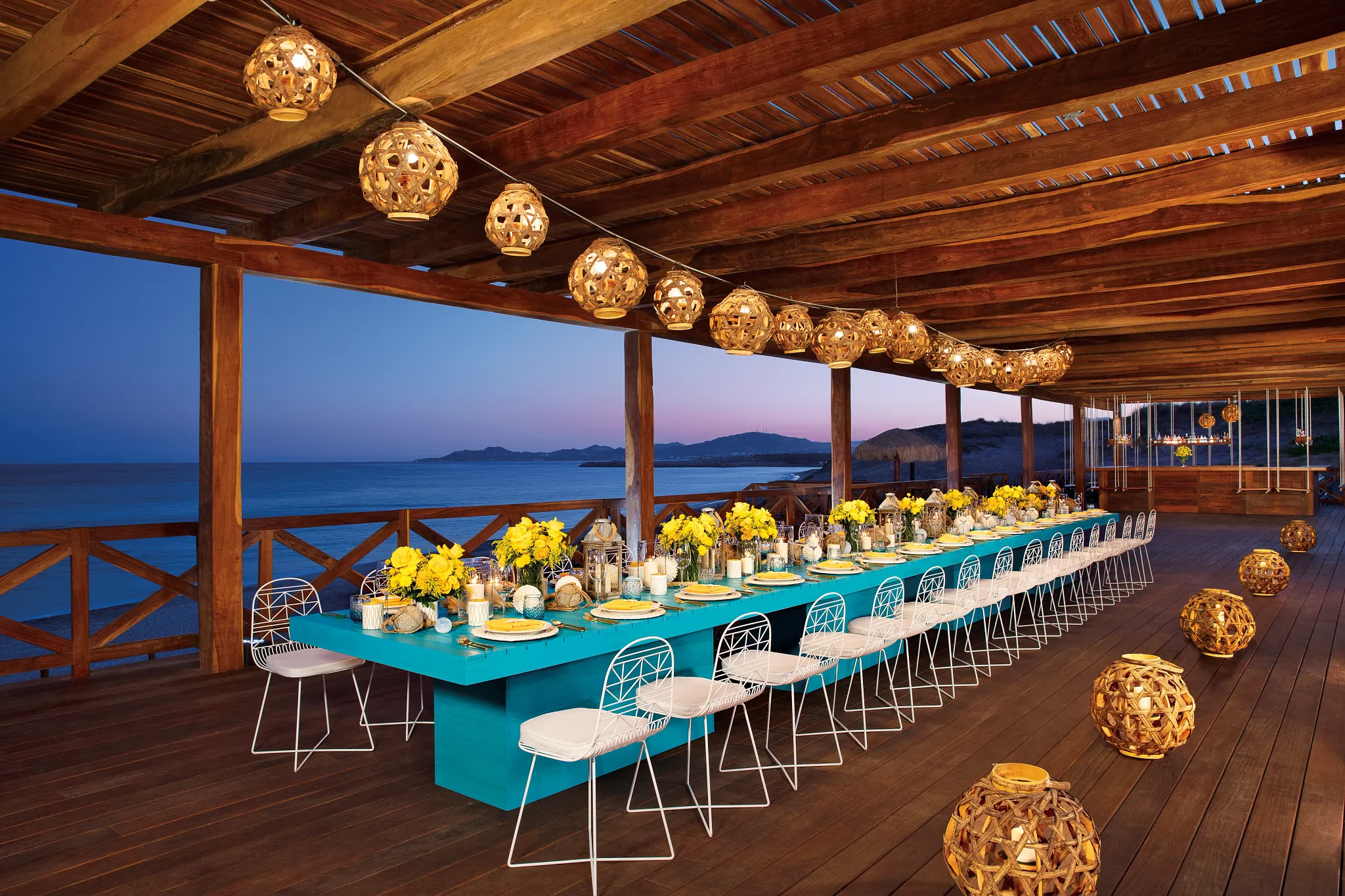 Barracuda Deck oceanfront dinner setup at sunset at Secrets Puerto Los Cabos