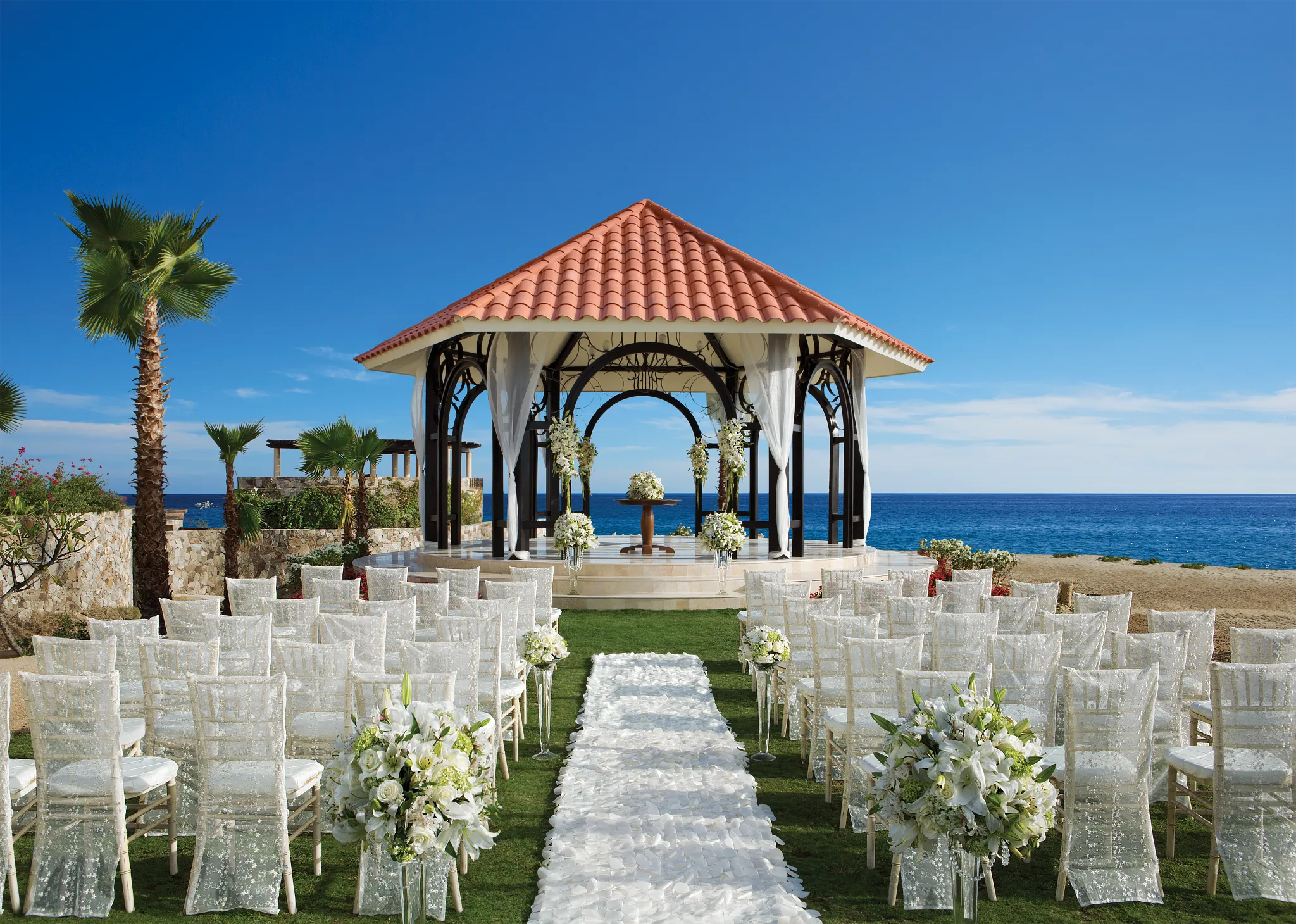 Oceanfront gazebo wedding ceremony setup at Secrets Puerto Los Cabos