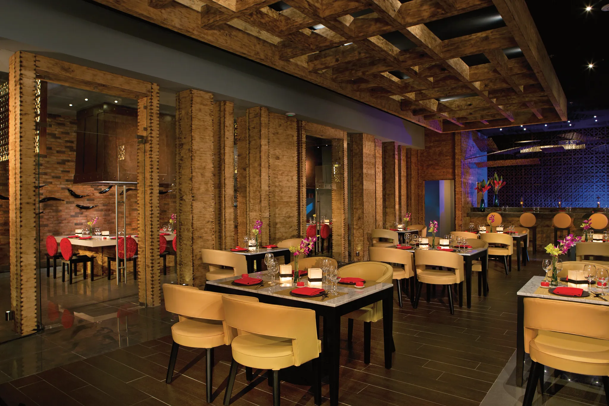 Himitsu Pan-Asian restaurant at Secrets Puerto Los Cabos featuring Teppanyaki tables, modern Asian décor, and elegant dining ambiance.