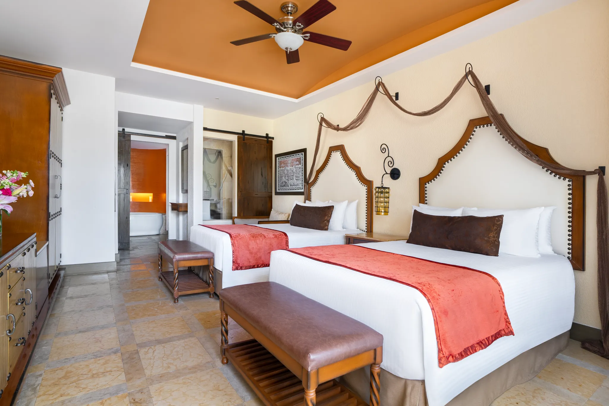 Junior Suite Swim Out Garden View with two double beds and terrace access at Secrets Puerto Los Cabos Resort.