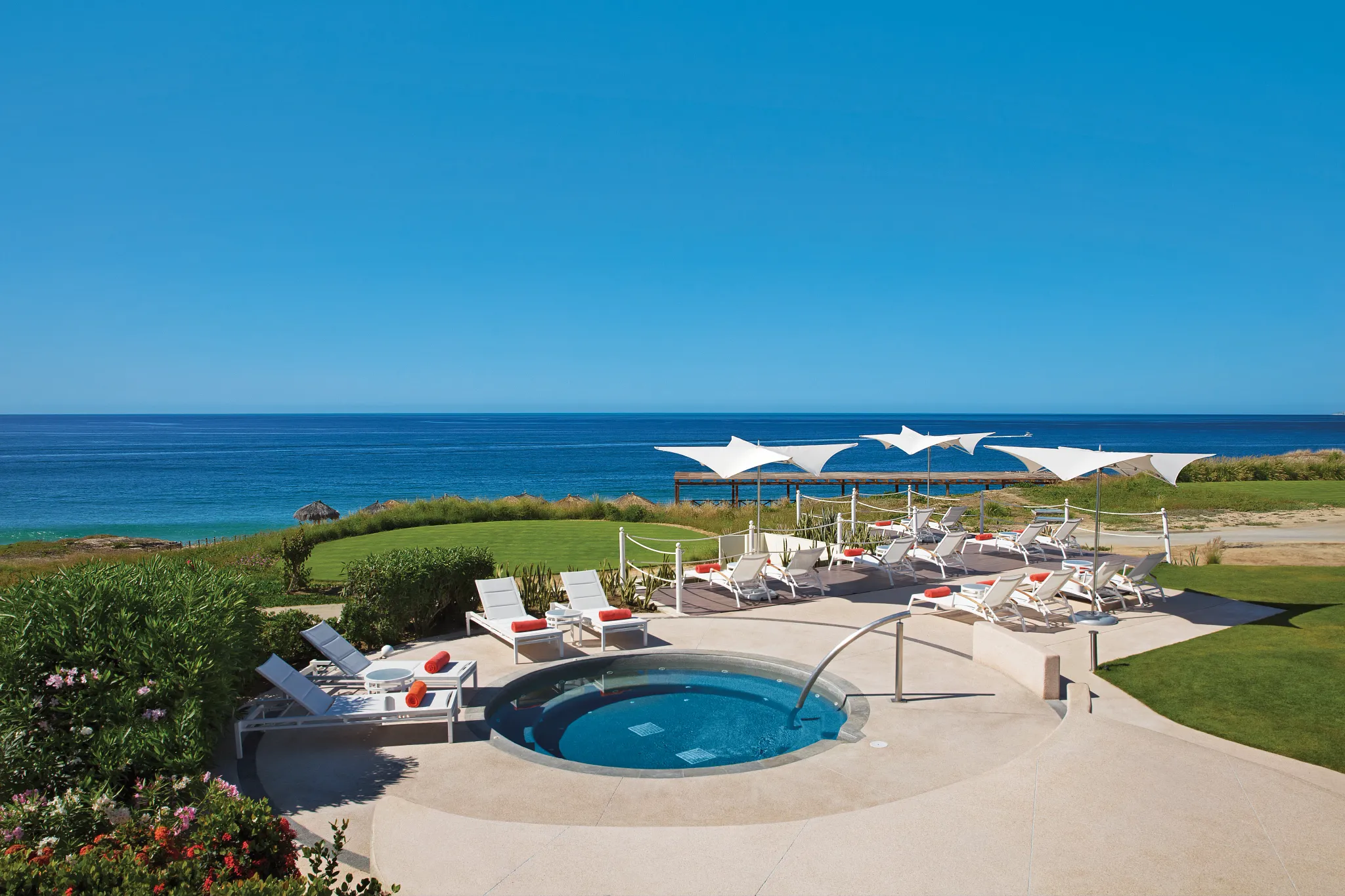 Oceanfront whirlpool and lounge deck at Secrets Puerto Los Cabos with sea views.