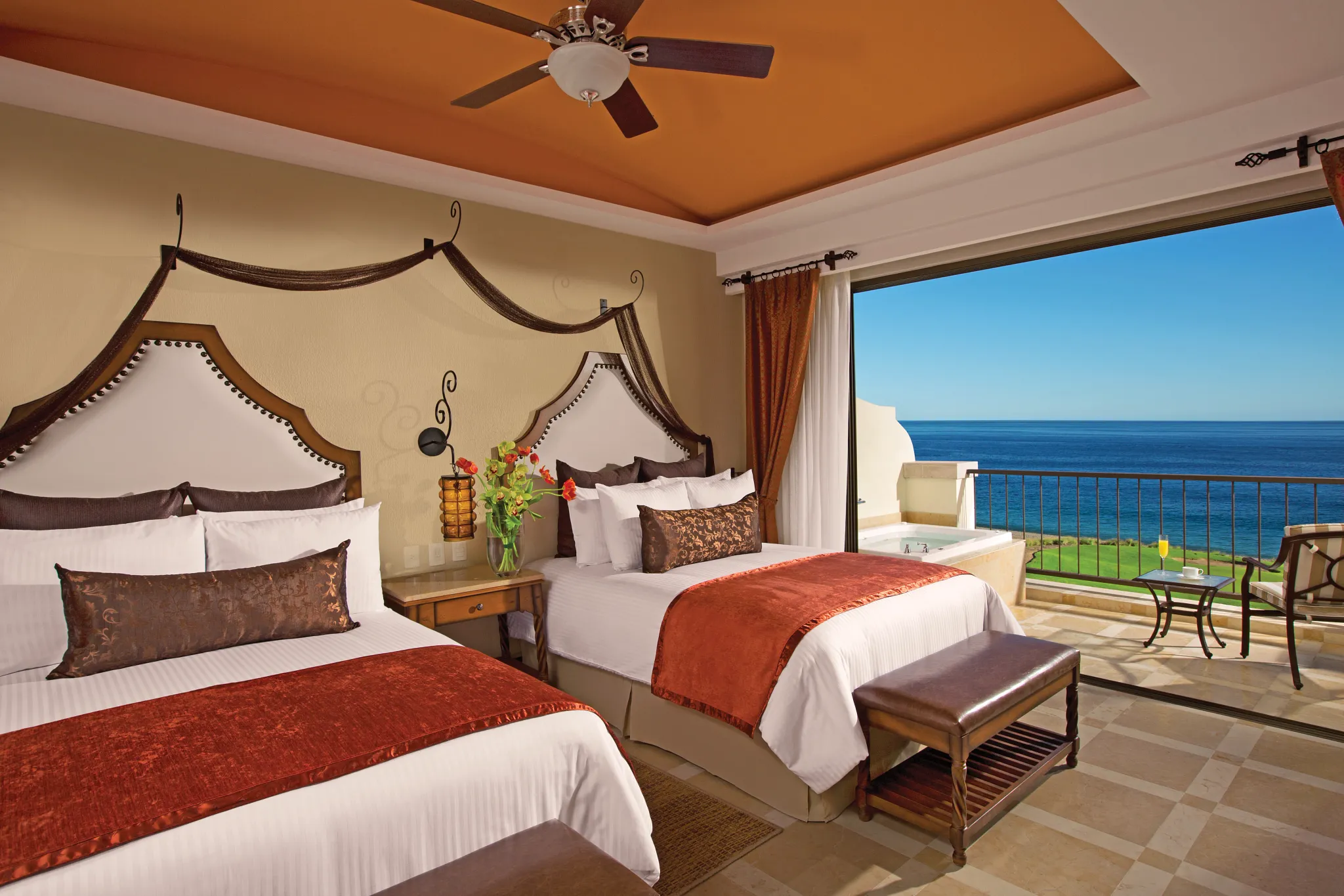 Preferred Club Junior Suite Ocean Front with two double beds and balcony overlooking the ocean at Secrets Puerto Los Cabos.