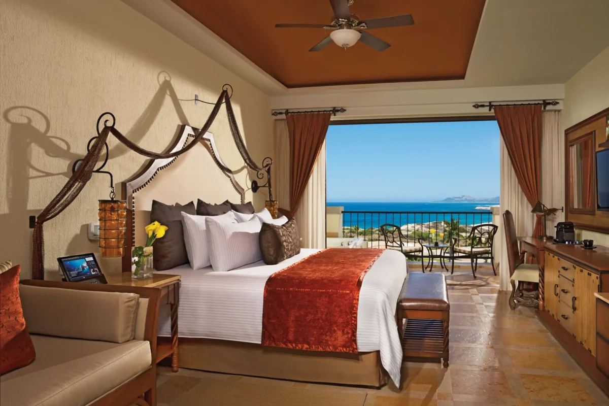 Preferred Club Junior Suite Ocean View with king bed and balcony overlooking the ocean at Secrets Puerto Los Cabos.