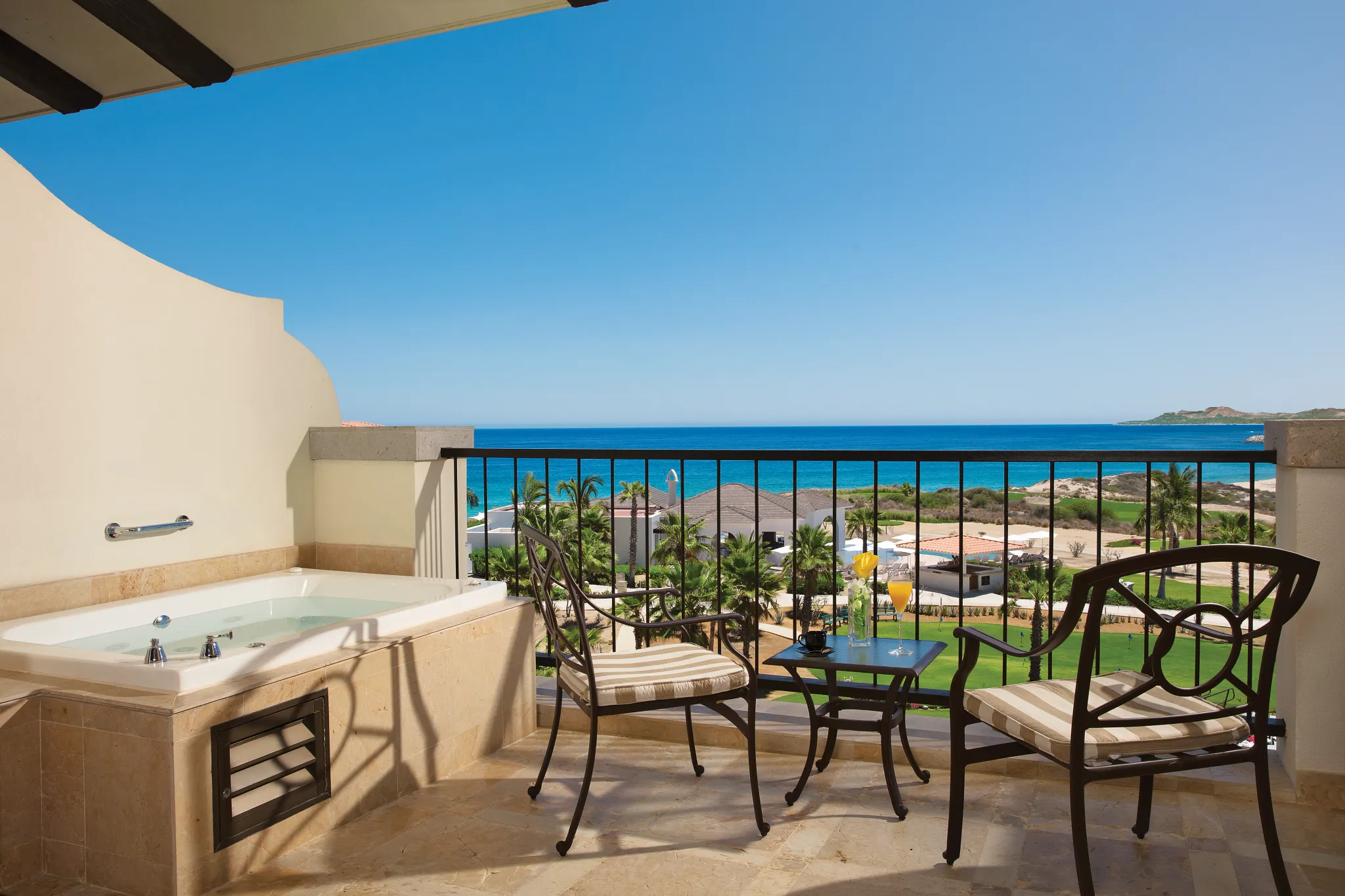 Preferred Club Junior Suite Ocean View terrace with hot tub and ocean views at Secrets Puerto Los Cabos Resort.