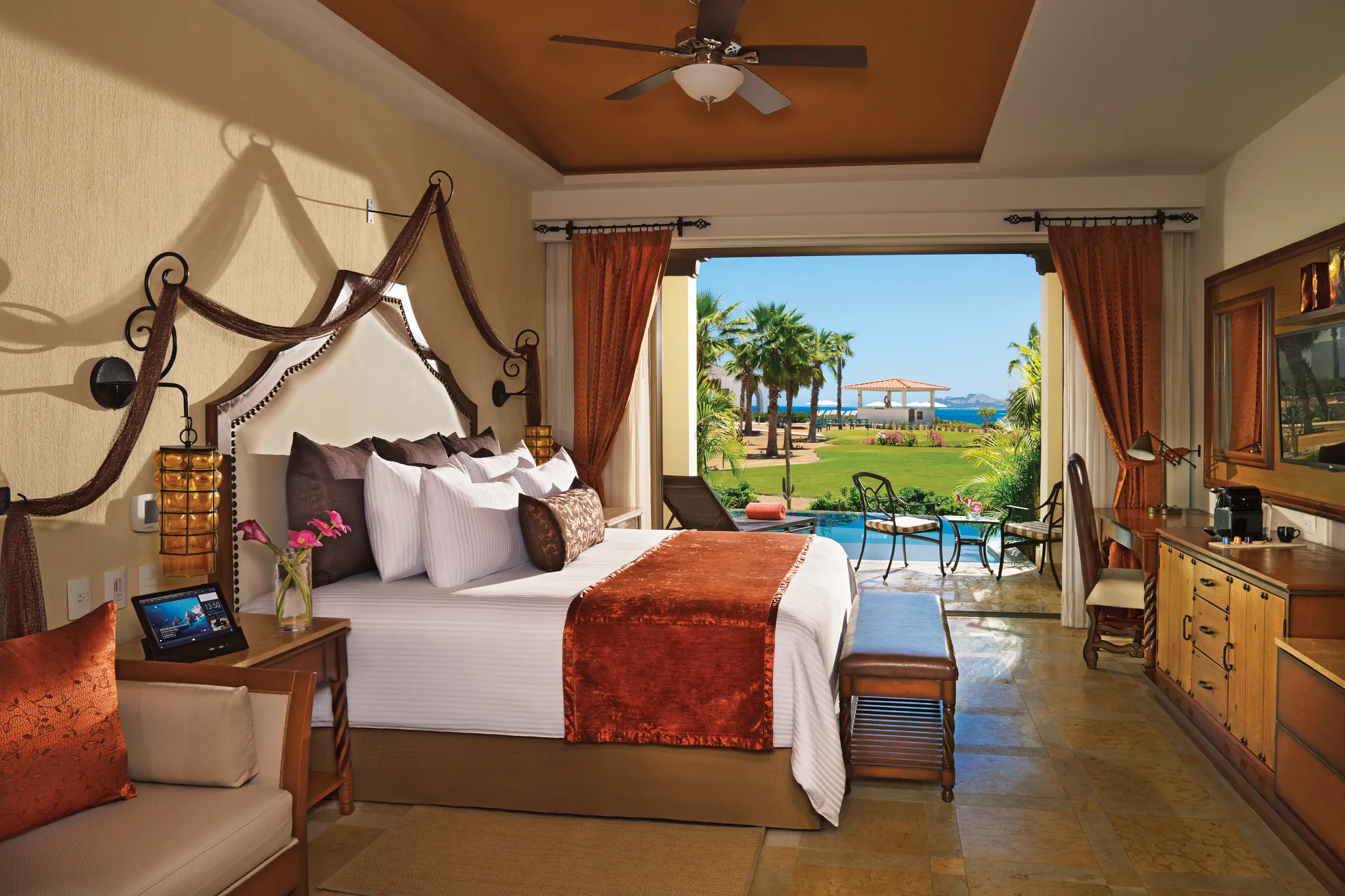 Preferred Club Junior Suite Swim Out with king bed and terrace leading to pool at Secrets Puerto Los Cabos.
