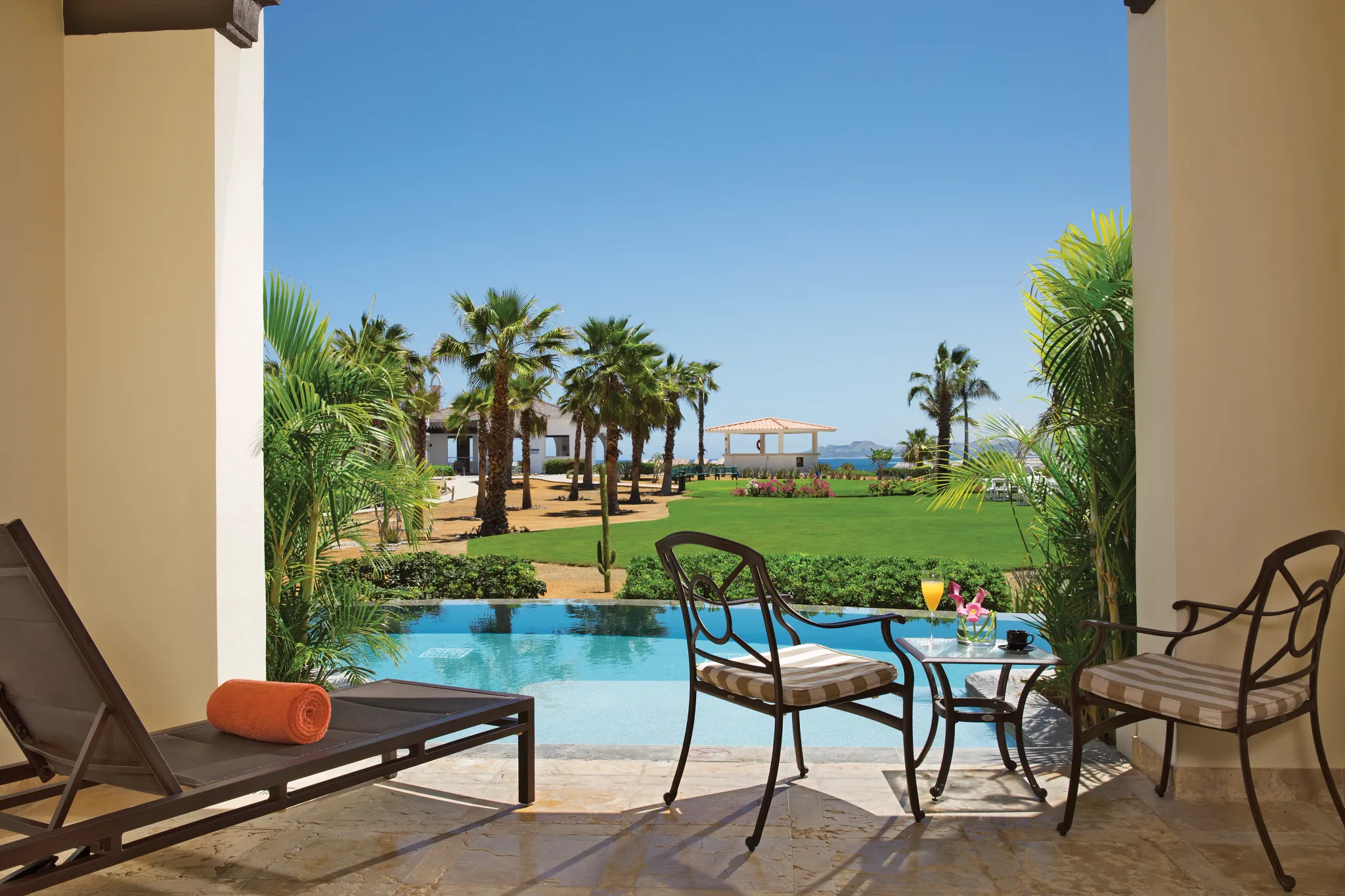 Preferred Club Junior Suite Swim Out terrace with pool access and garden views at Secrets Puerto Los Cabos Resort.
