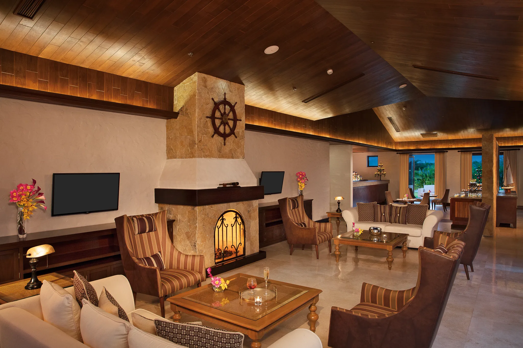 Cozy Preferred Club lounge with fireplace and seating at Secrets Puerto Los Cabos.