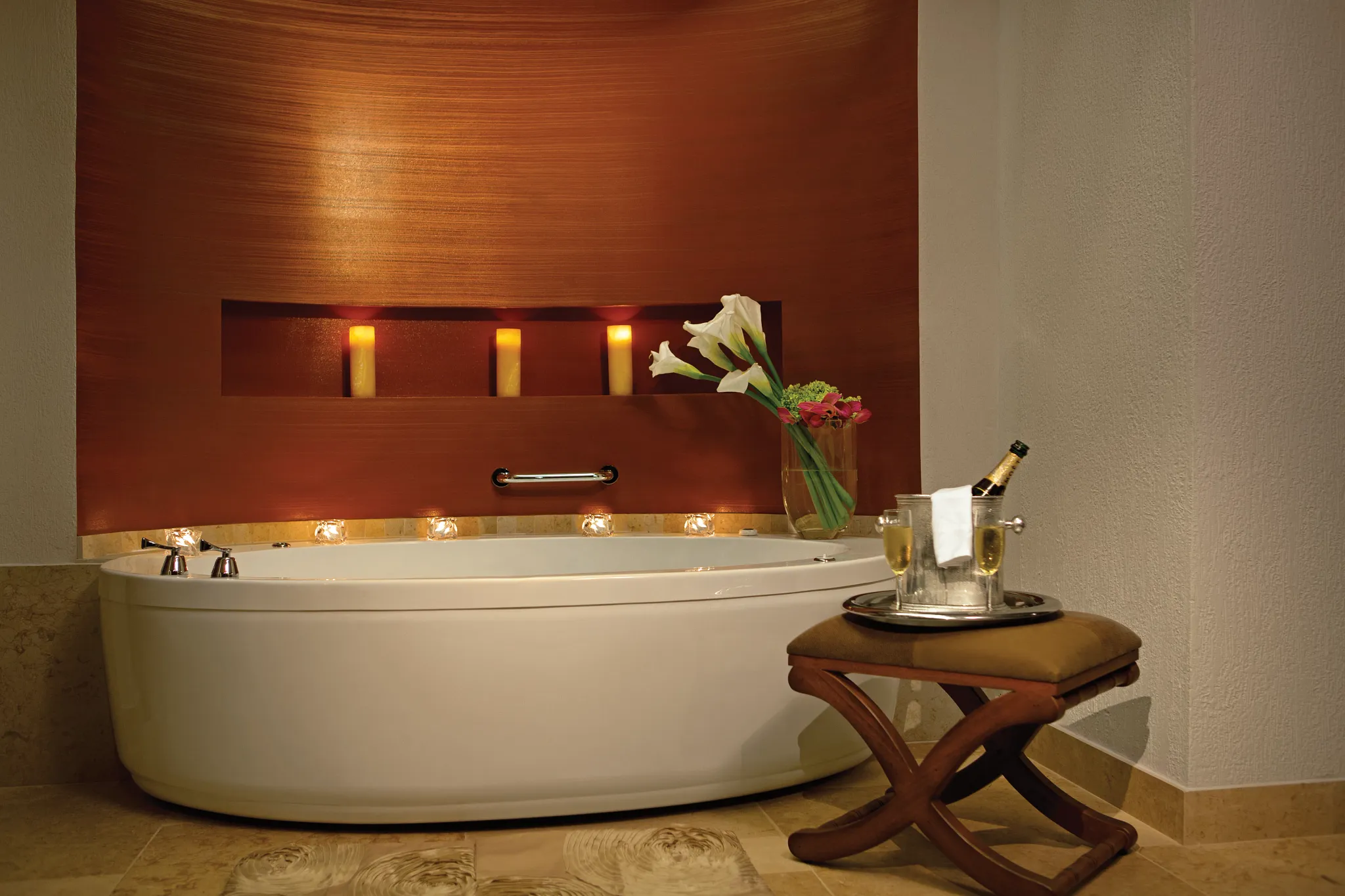 Presidential Suite bathroom with soaking tub and candle accents at Secrets Puerto Los Cabos Golf & Spa Resort.