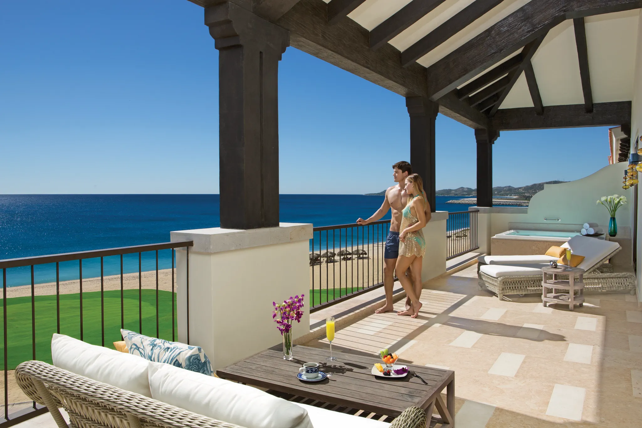 Presidential Suite terrace with couple overlooking ocean at Secrets Puerto Los Cabos Golf & Spa Resort.