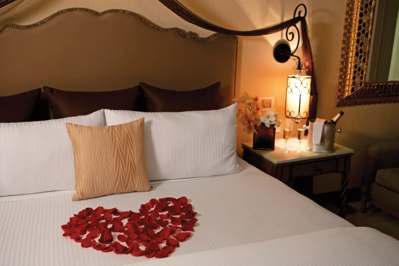 Presidential Suite bedroom with romantic turndown and rose petals at Secrets Puerto Los Cabos Golf & Spa Resort.