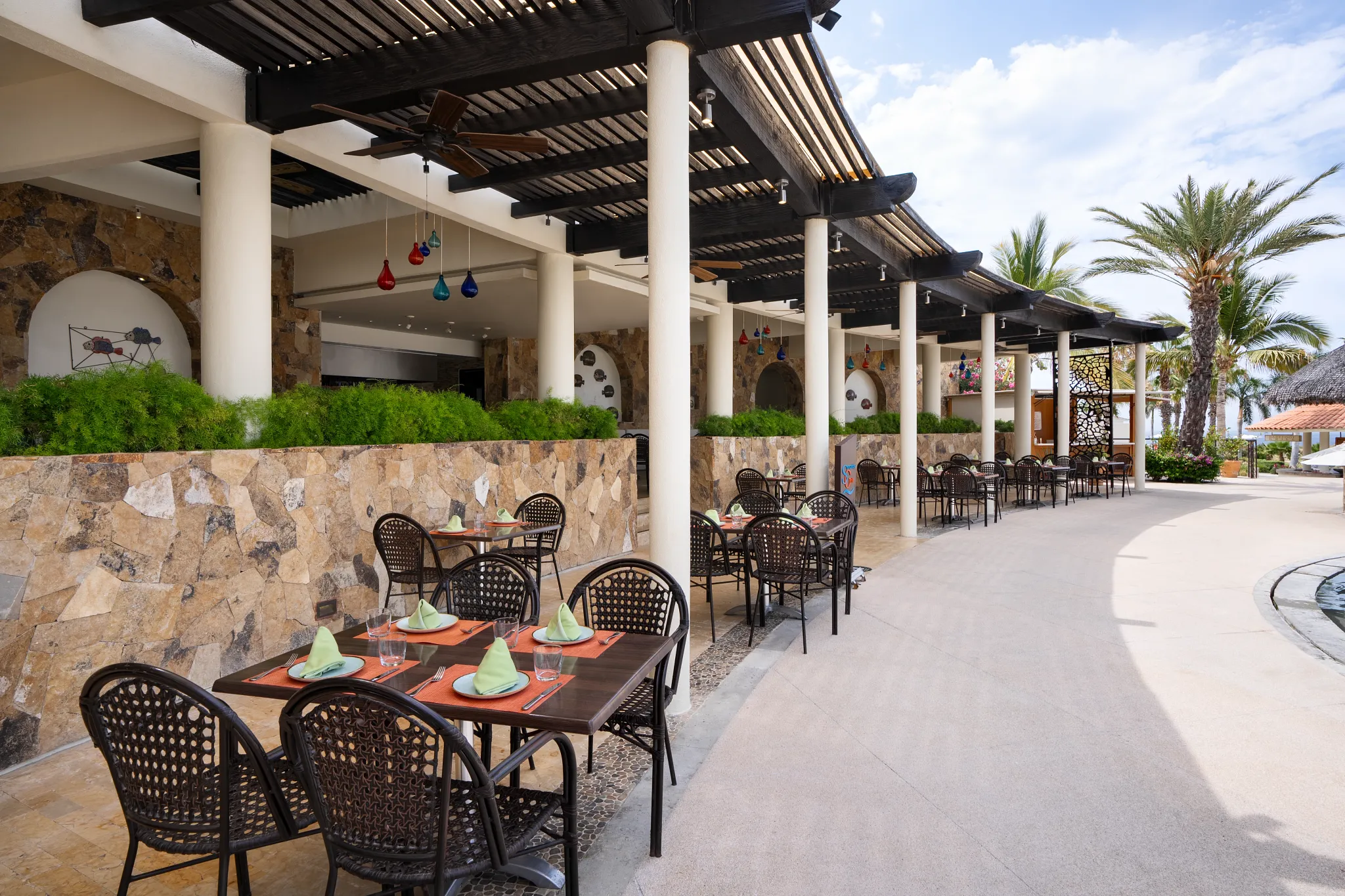 Seaside Grill at Secrets Puerto Los Cabos featuring poolside dining, ocean views, and a casual open-air grill setting.