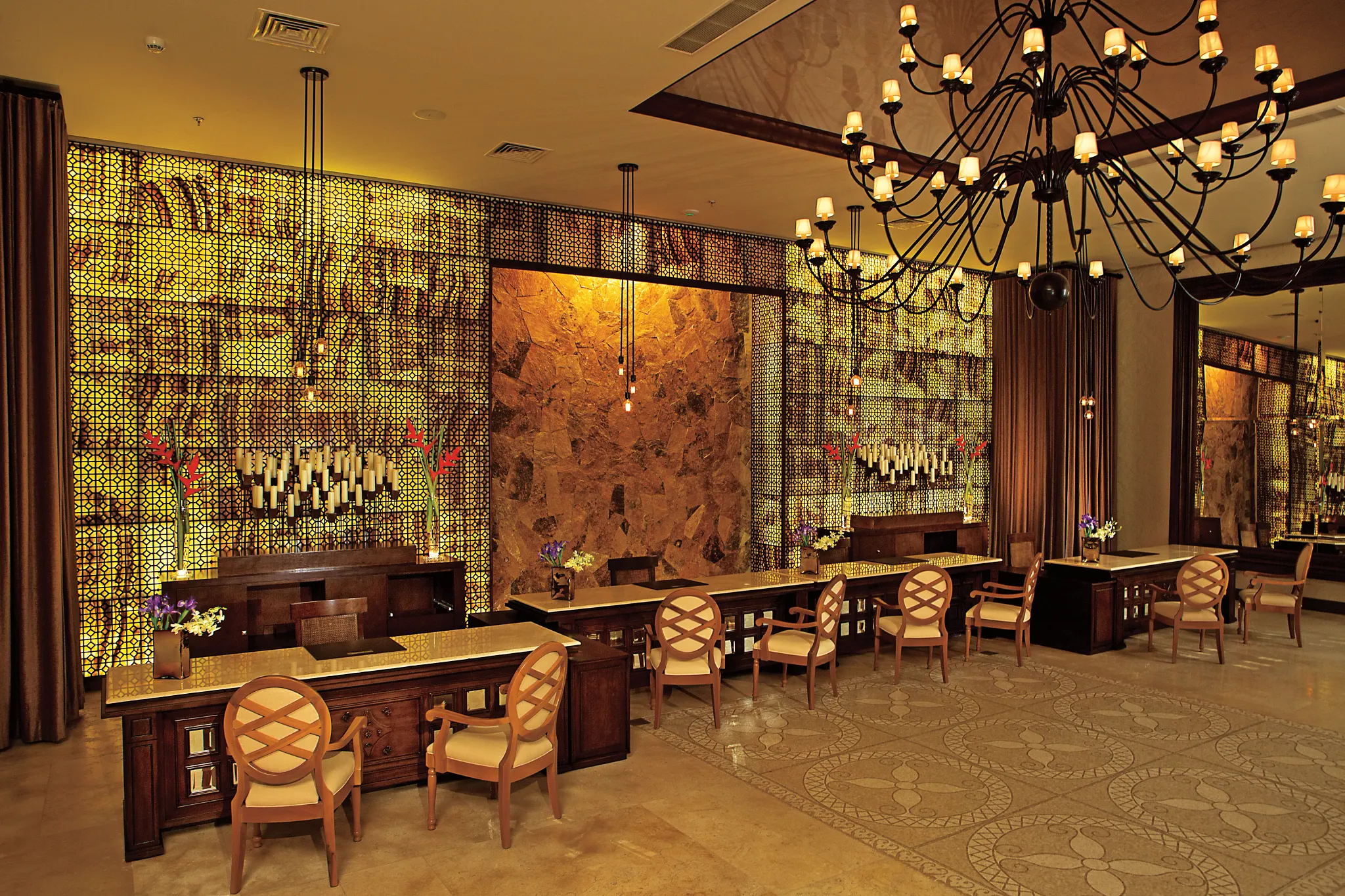 Elegant spa reception with warm lighting and decorative screens at Secrets Puerto Los Cabos.