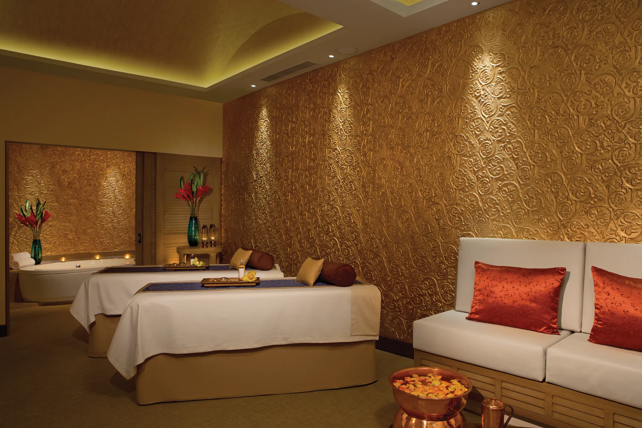 Luxury spa treatment room with massage tables and ambient lighting at Secrets Puerto Los Cabos.